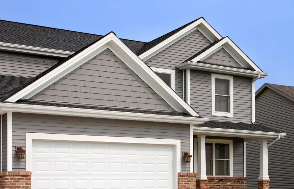 A picture of a grey house with white trim and white gutters in Slidell, LA
